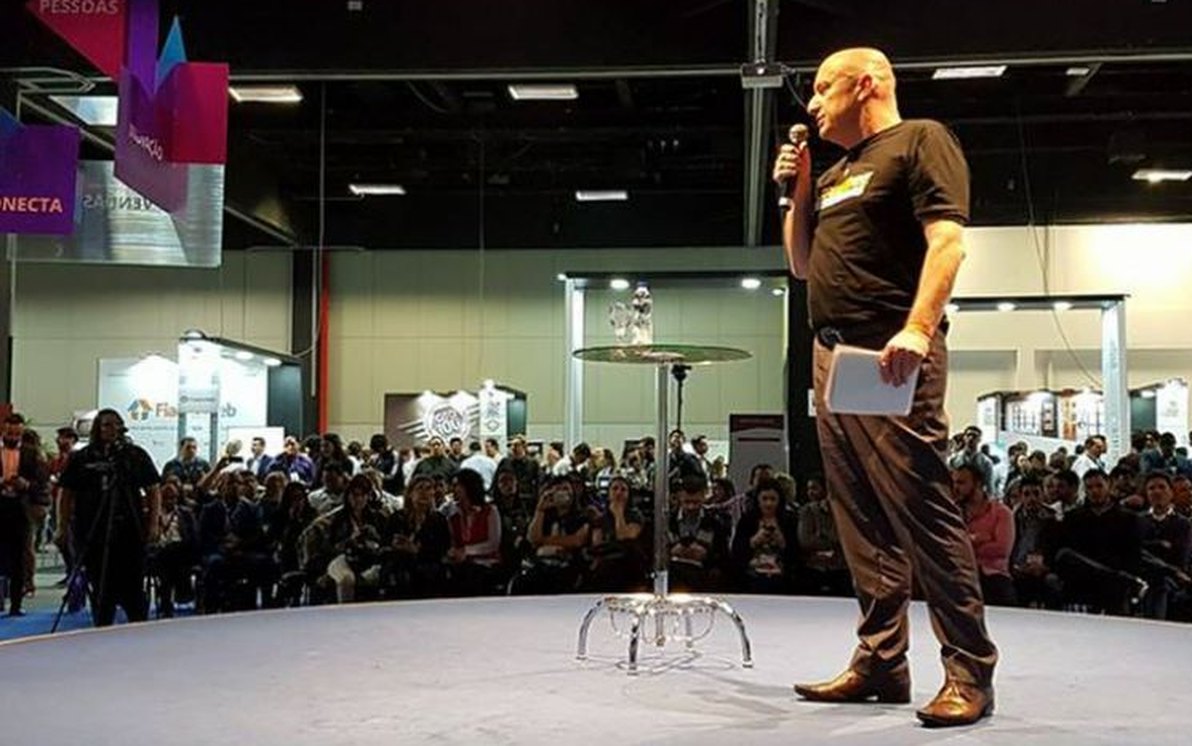 Edmilson Rene no palco do Conecta Imobi, falando ao microfone diante da plateia